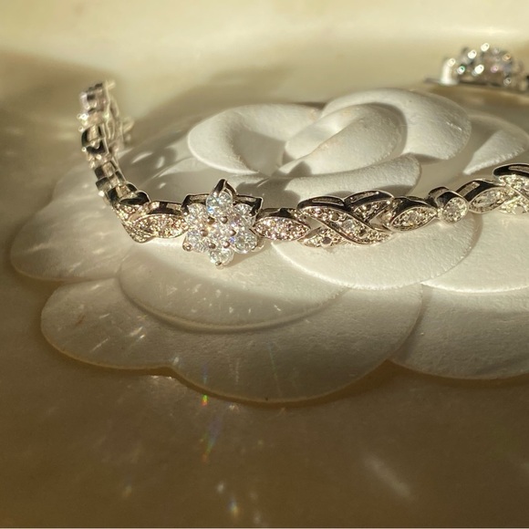 Stunning silver tone white CZ flower tennis bracelet